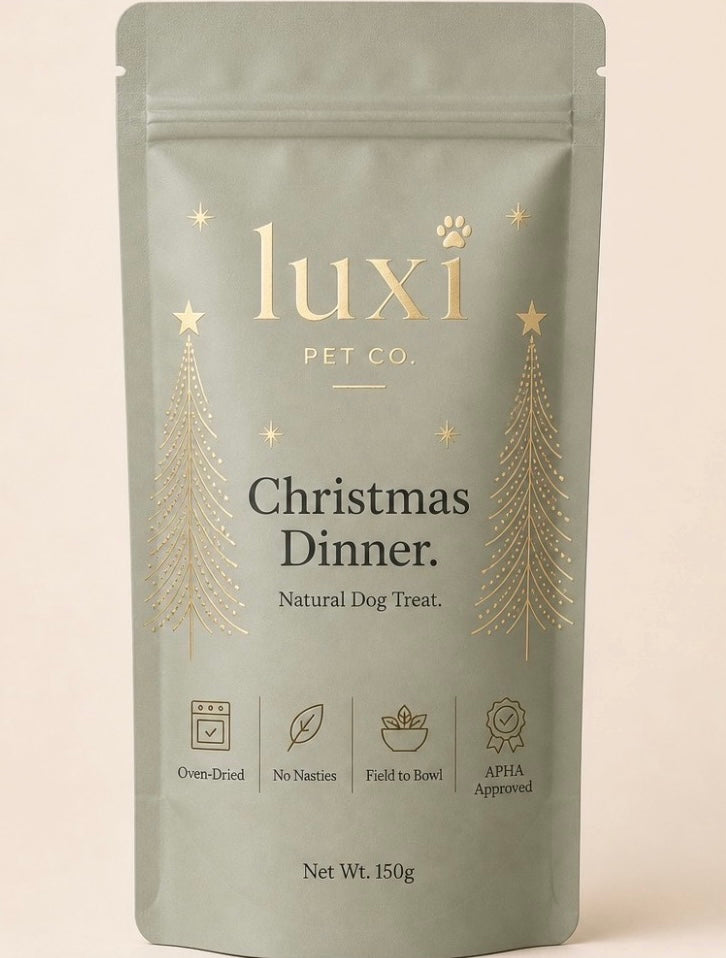 Luxi Christmas Dinner natural dog treats in a sage-green 150g pouch with gold Christmas tree designs
